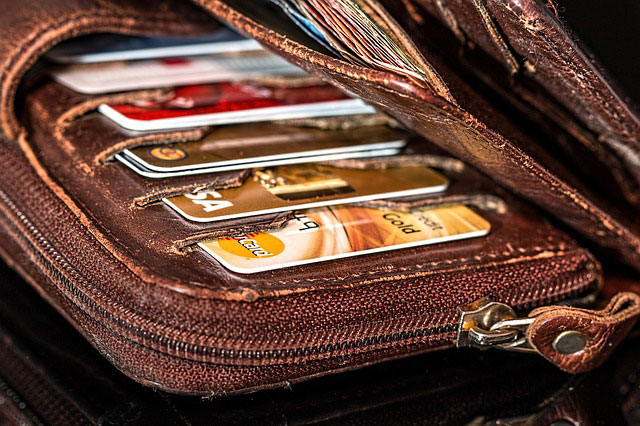 brown wallet with credit cards 