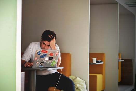 man worriedly looking at his laptop