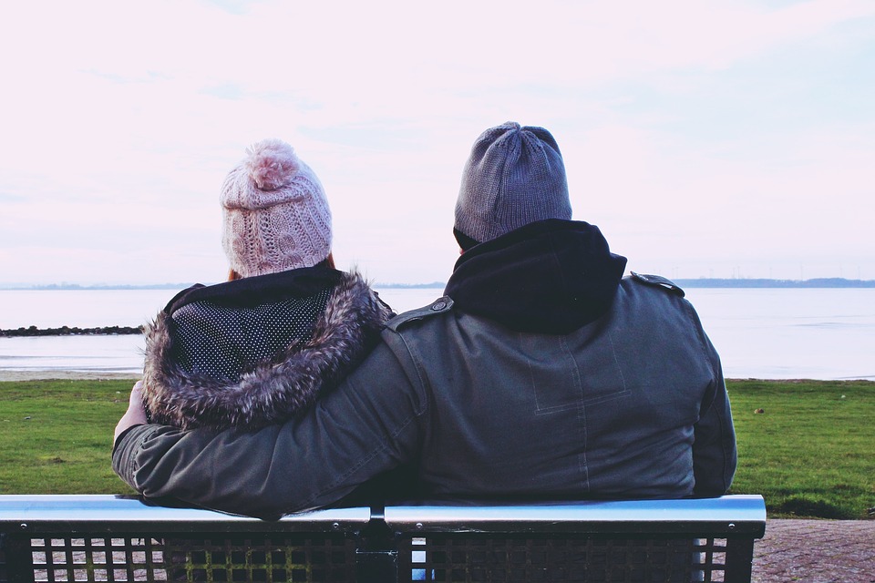 couples sitting in a bench