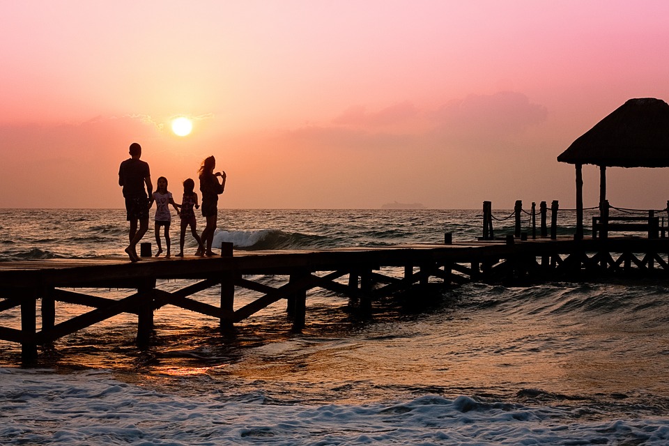 family walking in the beach 