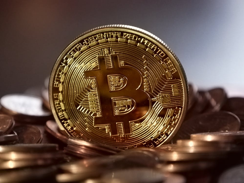 a gold coin with a bitcoin logo