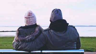 Couple sitting in a Bench